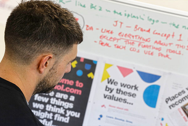 employee looking at a white board