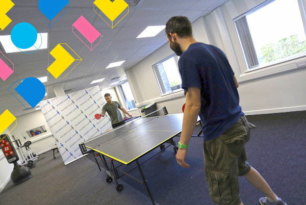 employees playing table tennis